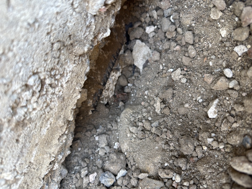 Damaged reinforcement exposed at a slab edge, recorded on a pre-handover inspection in Officer, 10 km from Pakenham East
